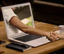handshake through a laptop